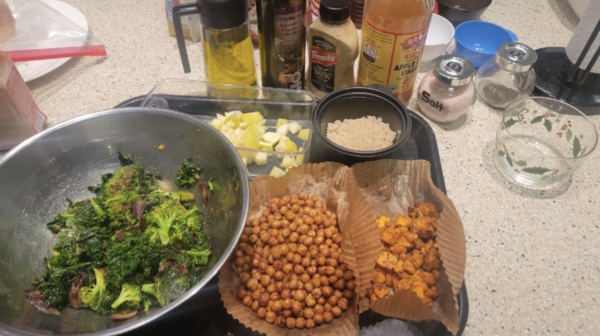 Side dishes from a cooking class for students with visual impairments. Dishes include broccoli in a large bowl in front of a row of spices.
